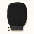 The Sunday Scrub exfoliating glove, front view on a cream background
